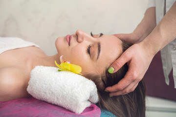 Obraz na płótnie Canvas young pretty woman receiving facial lifting massage at spa clinic
