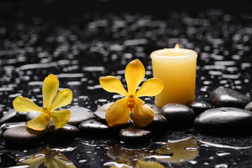 spa and zen concept ,yellow orchid,candle  close up with black zen stones,  - 580548837
