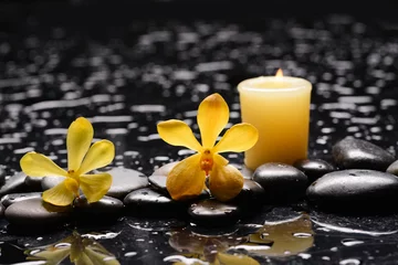 Fototapete spa and zen concept ,yellow orchid,candle  close up with black zen stones,  © Mee Ting