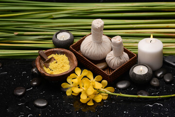 spa and zen concept ,yellow orchid with spa setting with black zen stones - 580548870