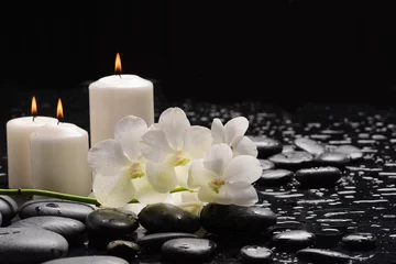 Rolgordijnen Spa still with white orchid, close up,candle with black zen stones, © Mee Ting