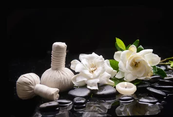 Deurstickers Spa still life of zen stones ,candle ,spa ball with drops and gardenia blooming  © Mee Ting