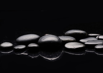 shiny dark spa stones with water drops, reflection  - 580549645