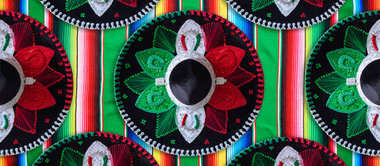 Mariachi hats with colors of the Mexican flag on serape. Colorful banner.
