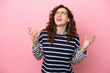 Young caucasian woman isolated on pink background smiling a lot