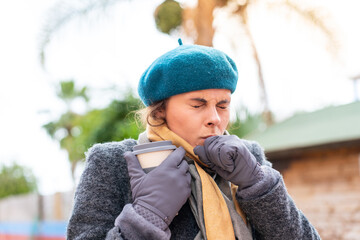 Brunette woman holding a take away coffee at outdoors