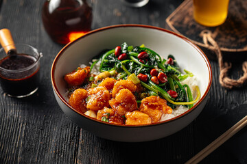 Portion of asian rice dish with shrimp and spinach