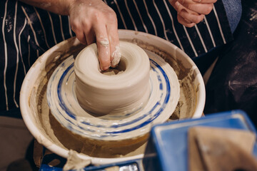 Master class on modeling of clay on a potter's wheel In the pottery workshop