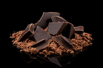 Pile of Cocoa powder and chocolate pieces isolated on black background