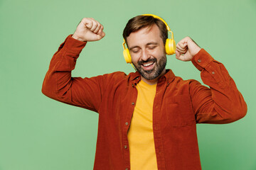Elderly fun man 40s years old he wear casual clothes red shirt t-shirt listen to music in...