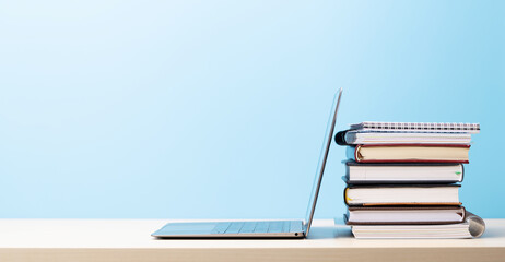 Laptop and stack of notepads