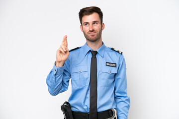 Young police caucasian man isolated on white background with fingers crossing and wishing the best