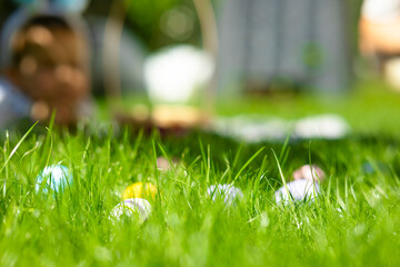 Easter colorful eggs on a green lawn. Beautiful festive Easter background, happy Easter, Sunday, Easter bunny. Beautiful postcard with space for copy