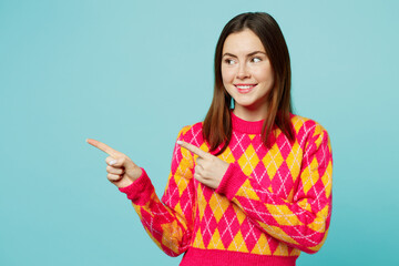 Young woman wear bright casual clothes point index finger aside indicate on workspace area copy space mock up isolated on plain pastel light blue cyan background studio portrait. Lifestyle concept.