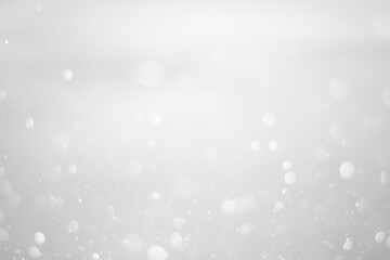 White glitter vintage lights background.  White bokeh shiny on dark background.