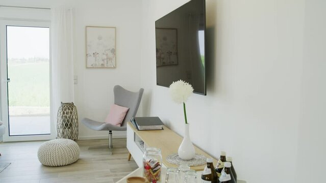 Bright living room with flatscreen and side table