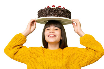 Little girl holding birthday cake over isolated chroma key background
