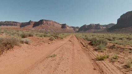 aerial FPV motion following the path in order to the huge cliffs in amazing Indian Creek with sunny day.