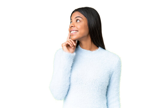 Young African American woman over isolated chroma key background thinking an idea while looking up