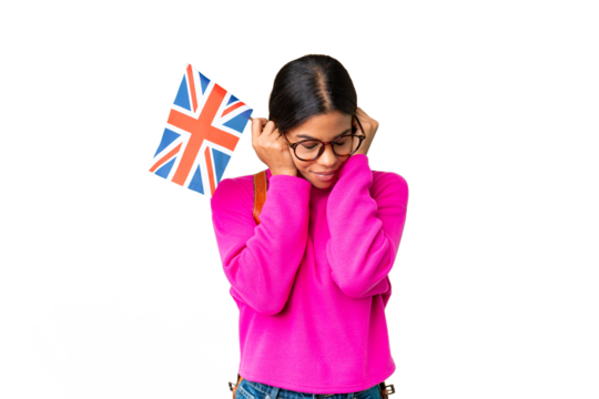 Young African American woman holding an United Kingdom flag over isolated chroma key background frustrated and covering ears