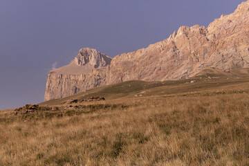 Mountain landscape - orange rocky bizarre cliff in bright sunny autumn day with clear blue sky and...
