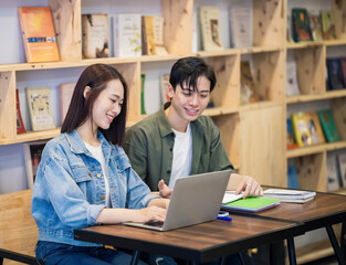 Young Asian couple studying at library