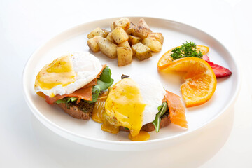 Salmon Benedict - poached eggs, hollandaise sauce, smoked salmon, pesto and rocket leaves served on ciabatta.