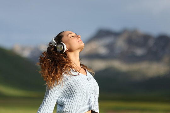 Woman meditating in nature listening audio guide