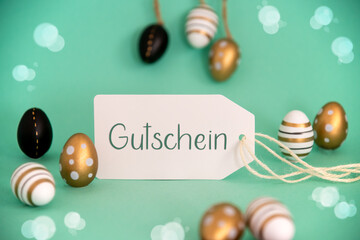 Fototapeta na wymiar Golden Easter Egg Decoration. Label With Gutschein Means Voucher