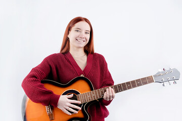 Young woman playing guitar isolated on white background