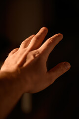 Fototapeta premium Man's hand in sunlight. Human hand anatomy reference. Natural light and shadows
