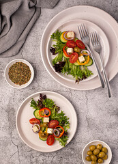 Food photography of  feta salad, greek, tomato, cucumber, onion, lettuce, sauce, bell, pepper, cheese, olive, vegetables