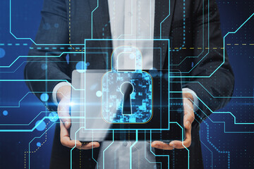 Close up of male hands holding tablet with glowing safety and security circuit padlock hologram on blurry background. Double exposure.