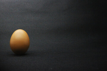 brown chicken eggs on a black background