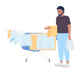 Bearded man standing near clothes drying rack semi flat color vector character. Editable figure. Full body person on white. Simple cartoon style spot illustration for web graphic design and animation