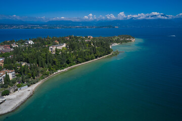 Fototapeta premium Morning photography with drone. Archaeological site of Grotte di Catullo, Sirmione, Italy early morning aerial view. lake garda. Tourist destination in Lombardy region of Italy