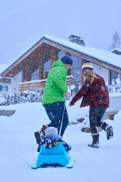 Happy mother and father with son enjoying in snow