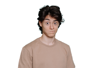 Close up portrait of surpised schoolboy in beige t-shirt standing against transparent background with wide opened eyes. Mockup, perplexed guy looks at camera in wondering. Promo, sale, discount.