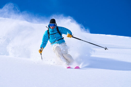Mature man skiing in powdered snow