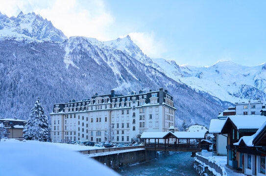 Buildings in front of snowcapped mountains