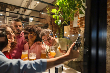 Woman taking selfie with friends at restaurant