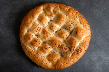Traditional Ramadan pita on black background.Holy bread for Muslims