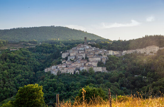 Italy, Tuscany,CastelnuovodiValdiCecina, View of hillside village and surrounding landscape in summer