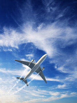 Vertical nature background with aircraft and Jet trailing smoke in sunset sky. Airplane and condensation trail