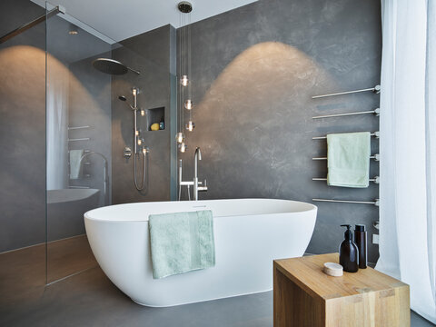 Empty bath tub arranged in bathroom of modern apartment