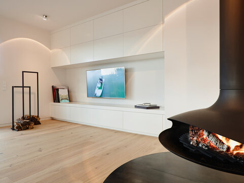 Interior of modern living room with television set and fireplace at home