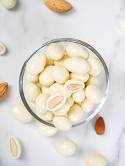 dragee from almonds in white chocolate. Chocolate balls with nut filling.