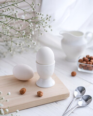 Fototapeta na wymiar Freshly boiled white egg on a wooden board. Healthy breakfast. Morning concept