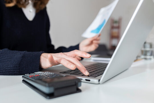 Businesswoman using laptop at desk