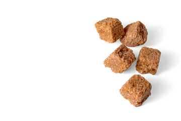 Pieces of brown cane sugar isolated on white background. Fragmen